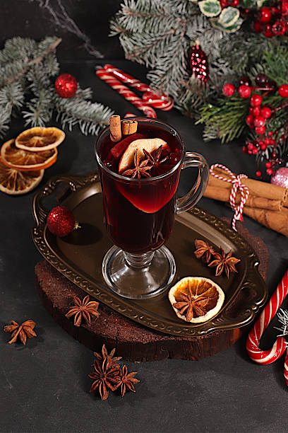 istock Mulled wine with spices, star anise, cranberry, orange, apple and cinnamon, a warming winter drink in the cold season, a strong alcoholic or non-alcoholic cocktail on the festive table, a 2248762386