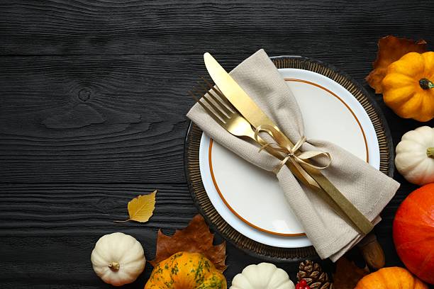 istock Close-up of table setting with pumpkins, dinnerware, rustic napkin on a plates. Thanksgiving day 2248763073
