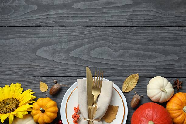 istock A cozy fall table setting with pumpkins, dinnerware in a rustic napkin on a plate, and holiday decor 2248763121
