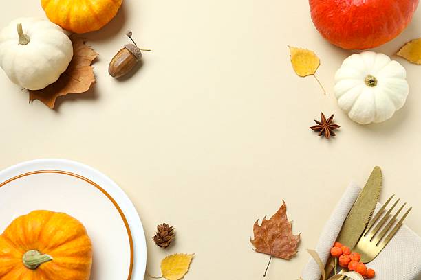 istock Beautiful table setting with orange pumpkins on beige background 2248763449