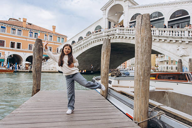 istock Happy girl posing on dock in Venice, Italy 2248767106