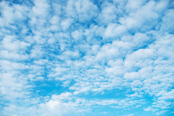 istock Fluffy white clouds scatter across a vibrant blue sky, creating a peaceful and serene cloudscape. The image captures the beauty of a clear day, evoking tranquility and calm. 2248767184