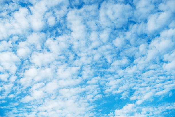 istock Fluffy white clouds scatter across a vibrant blue sky, creating a peaceful and serene cloudscape. The image captures the beauty of a clear day, evoking tranquility and calm. 2248767224