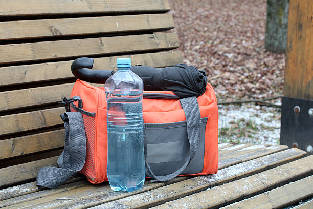istock Bag, water bottle, and umbrella left on park bench 2248767943