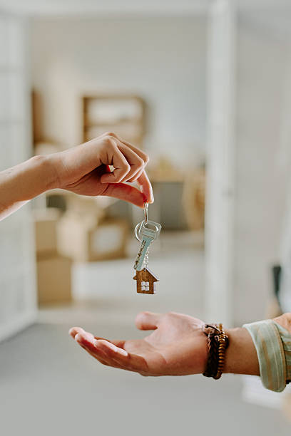 istock Couple Exchanging House Keys While Moving into New Home 2248769403