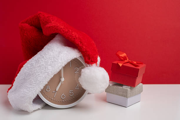 istock Santa hat concealing present on soft color background. Surprise christmas gift. 2248769927