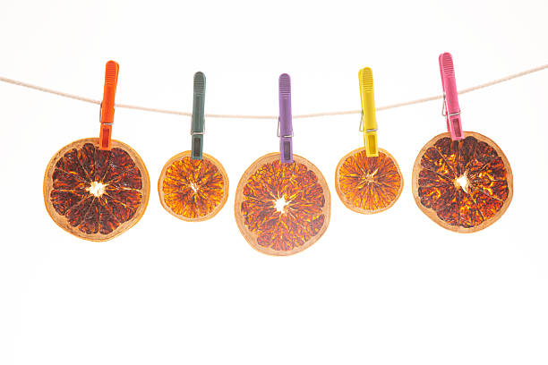 Sliced piece of dry dehydrated orange isolated on white background.