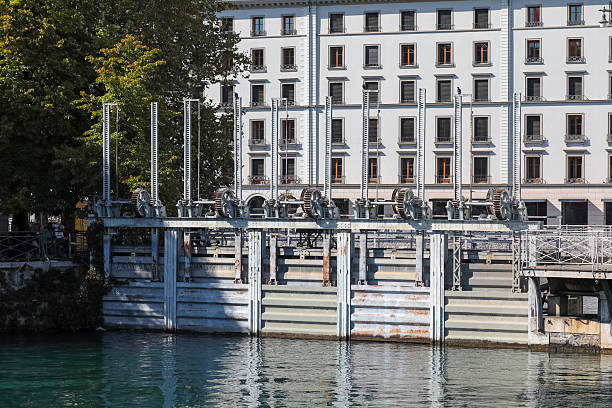 Geneva, Switzerland - September 19, 2025: These devices are part of old industrial structures located on the Rhône River. They were built to regulate the level of the river flowing from Lake Geneva.