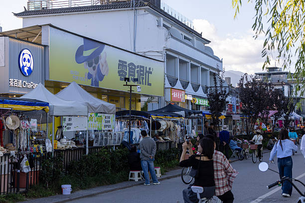 Dali, China - October 21, 2025: Sunny day in waterfront of Ehar. Stores and tourists on the background.