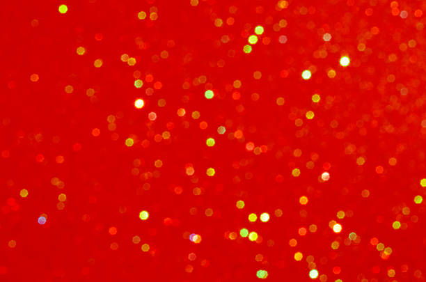 Bright red bokeh background with glittering spots for festive decor and celebration themes