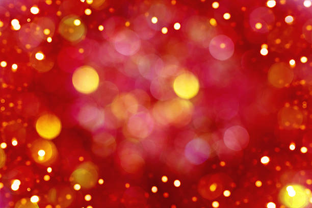 Vibrant red and gold bokeh background with soft circles of light, evoking warmth, celebration, and holiday mood.