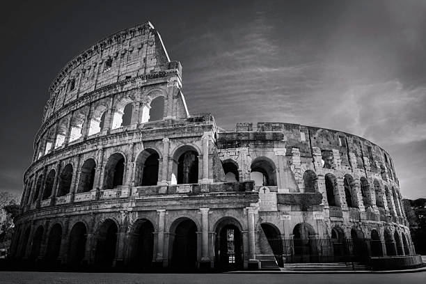 Colosseum in Rome captured in retrostyle black and white tones, highlighting ancient arches and timeless grandeur.