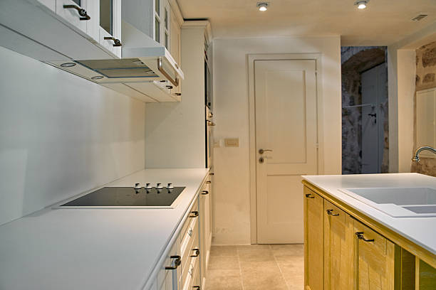 Under construction is new home with custom modular kitchen comprised of cabinets an island in center.
