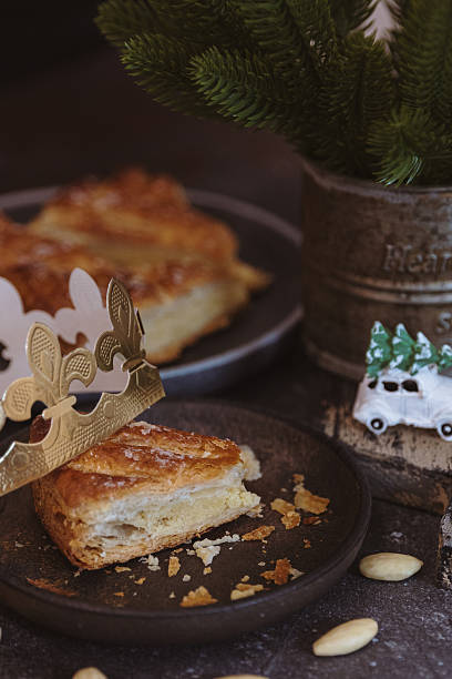 istock One bitten piece of galette in a plate with a toy on a dark table. 2248777355