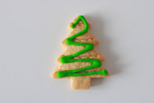 Christmas gingerbread cakes in the shape of a fir tree, colored in red, green and white
