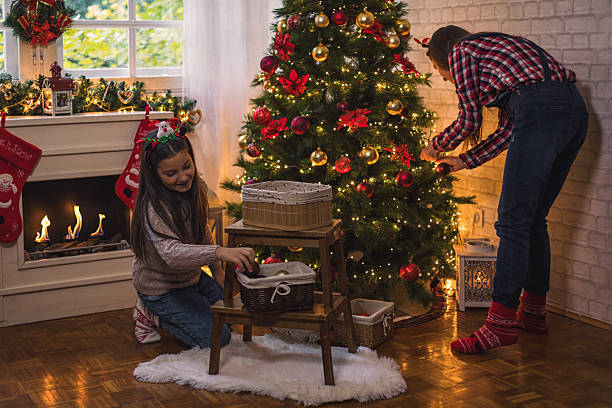 istock Family decorating Christmas tree at home 2248781259