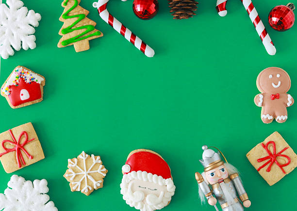 istock Festive Christmas cookies, ornaments, and decorations arranged on a green background with ample copy space for holiday messages, ads, or seasonal designs. 2248785391