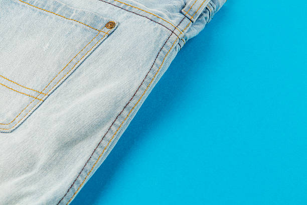 istock Light blue denim jeans on a bright blue background in a casual setting 2248785747