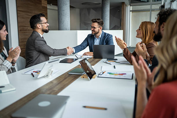 istock Business people shaking hands celebrating successful partnership deal 2248787533