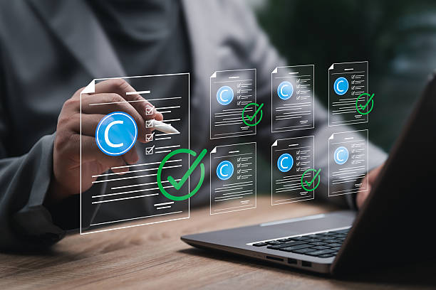 istock Intellectual copyright concept, Businessman Reviewing and Approving Patent Documents online with Copyright and Intellectual Property Protection Symbols, Ensuring Legal Compliance Against AI Misuse 2248789316