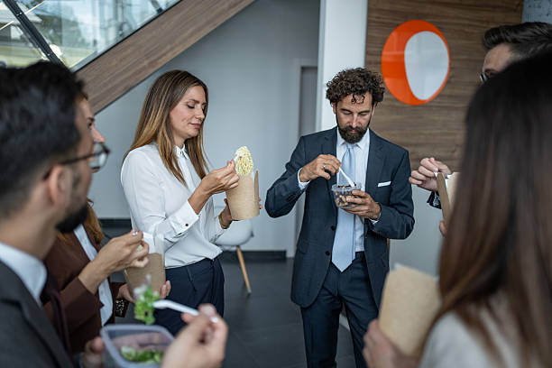 istock Business colleagues enjoying takeaway lunch during office break 2248789368