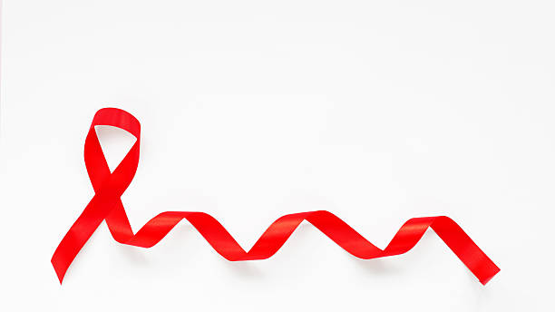 istock Red ribbon on white background symbolizing HIV and AIDS awareness, prevention and support 2248791951