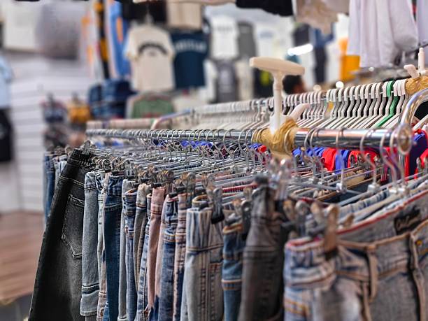 istock Jeans made of denim, hung on a hanger inside the store. 2248792535