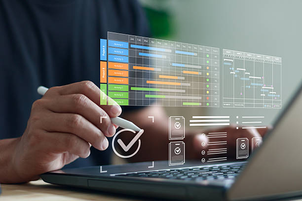 istock professional managing project timelines with digital Gantt charts, task tracking, and workflow planning tools, highlighting productivity, scheduling, and efficient project management in a tech workspace. 2248792820