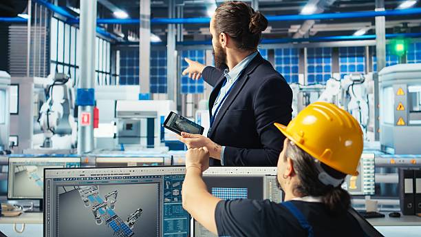 istock Manager instructs solar panels plant employee on how to use CAD software 2248793410
