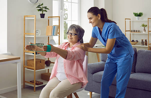 istock Elderly active woman exercising with blue elastic band 2248797307