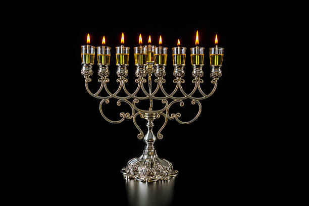 Beautifully crafted silver menorah with glowing candles displayed Hanukkah celebration