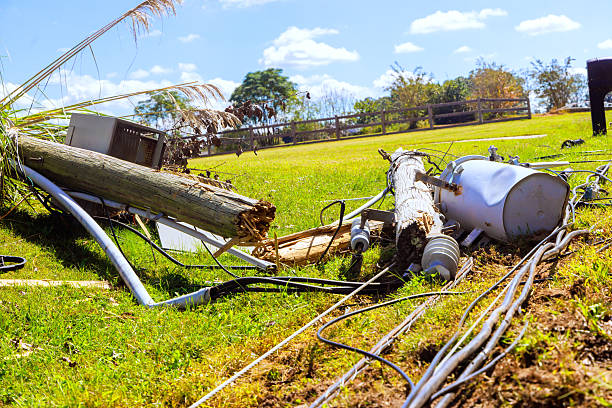 istock Storm damage reveals fallen utility pole tangled wires on grassy field 2248799524