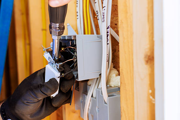 istock Electrician works on electrical panel in home installation 2248799639