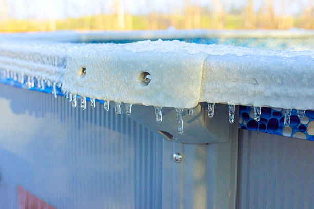 istock Frozen droplets form icicles on edge of pool during winter 2248800347