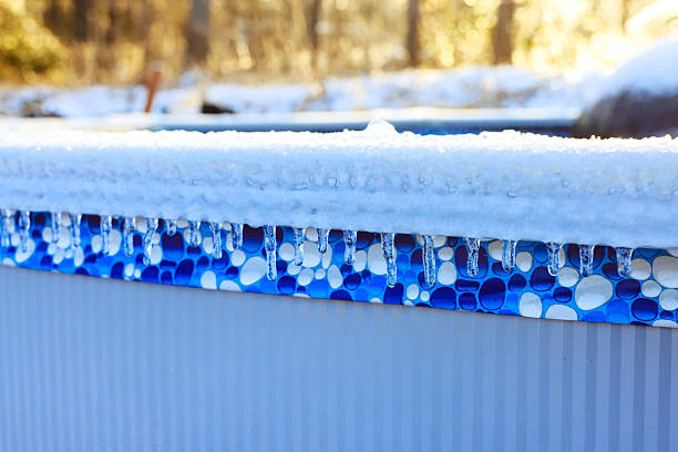 istock Icicles hang from edge of pool surrounded by winter landscape forest setting 2248800350