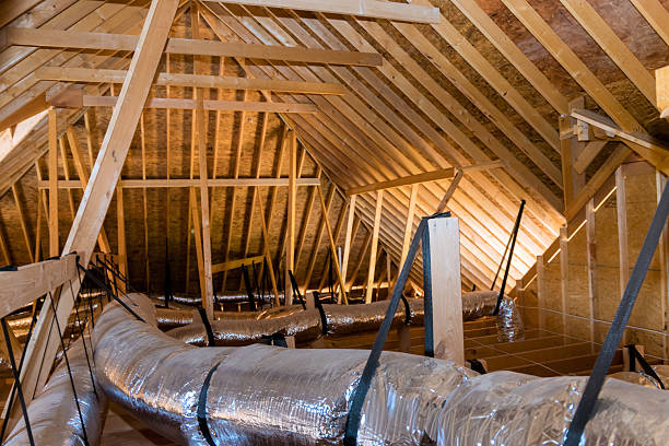 istock Ventilation ducts in modern attic with wooden beams light illuminating space 2248800366