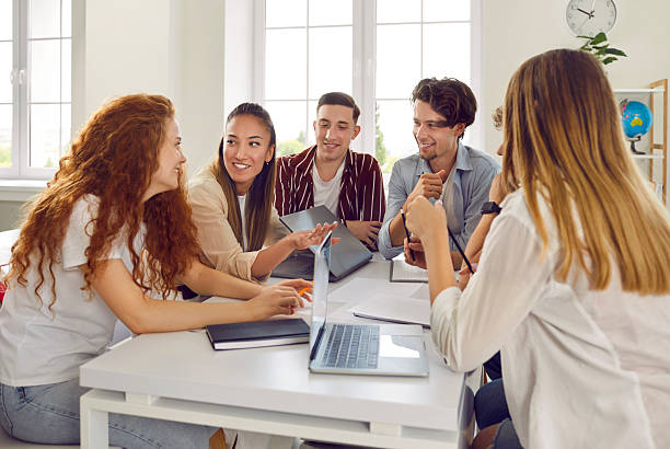 istock Group of happy college or university students working on a project and having a discussion 2248800535