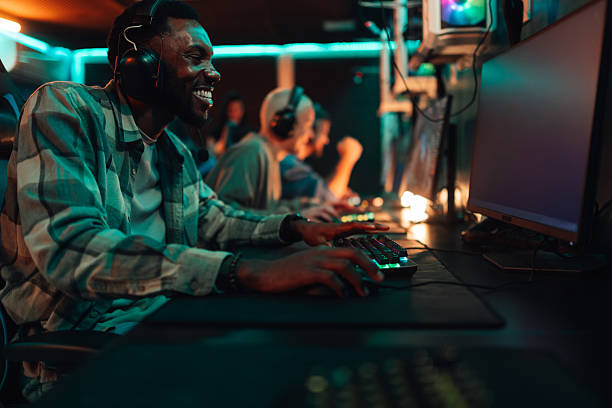 istock Young black man laughing playing video games 2248800947