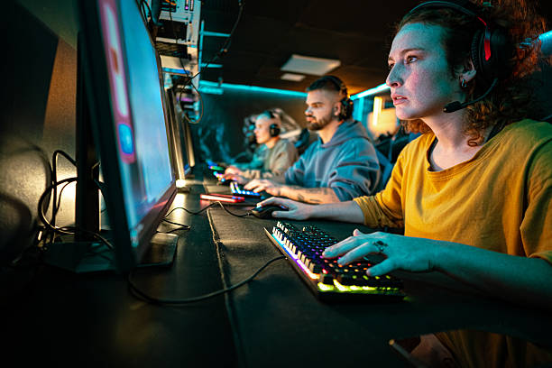 istock Young people playing competitive video games at cyber cafe 2248800950