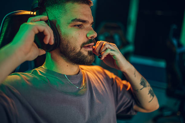 istock Young man adjusting headset for online gaming 2248801054