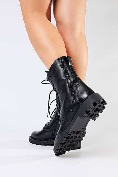 istock Women's black spring boots made of genuine leather are dressed on bare feet 2248801086