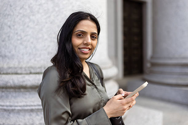 istock Confident Businesswoman Using Smartphone in Urban Setting 2248801933