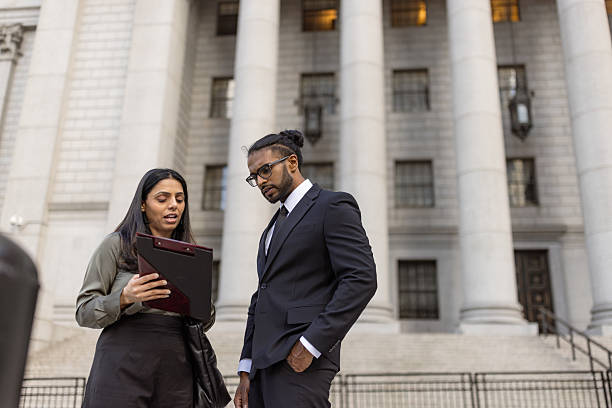 istock Business Professionals Discussing Work Outside Office Building 2248801950