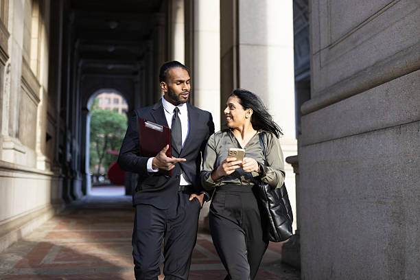 istock Business professionals walking and talking in city walkway 2248801984