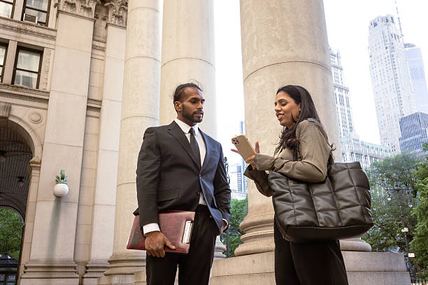 istock Business colleagues discussing work outdoors in urban setting 2248801994