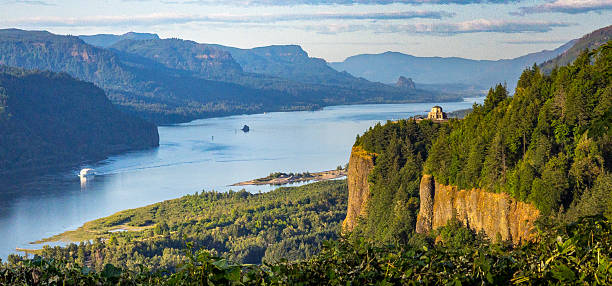 Breathtaking landscape of the Columbia River Gorge, featuring the stunning Vista House at Crown Point nestled among lush greenery.