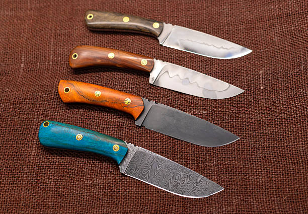 Two handmade hunting knives on a black background.