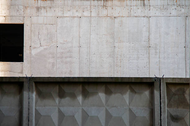 Texture Concrete Wall Frame with window hole, floor slab Building under Construction with Formwork Prints Smudges on Surface. Architectural origin of Structure. Monolithic fence at Construction Site
