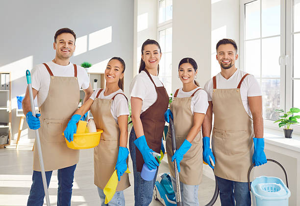istock Happy janitors in uniform from professional cleaning service looking at camera. 2248807231