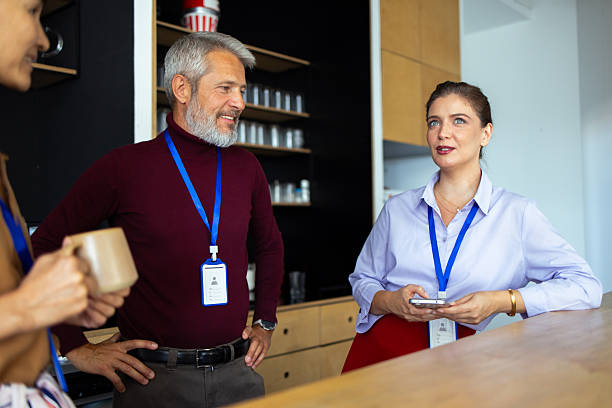 istock Business people wearing id badges chatting in office break room 2248808324